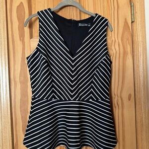 Like new, New York and Company black snd white peplum top. Size medium